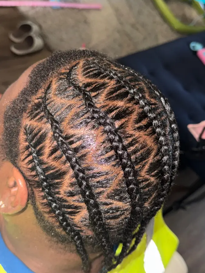 Feed-in cornrows with a curved design in Columbus, OH